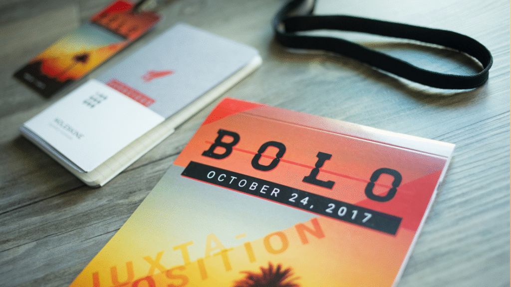 A booklet cover that reads: BOLO October 24, 2017, with a smaller booklet and a badge in the background.